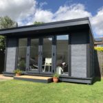 Side View Of Composite Garden Building With French Doors And Grey Panels