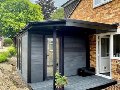 Attached Composite Garden Building With Side Canopy And Small Decking Area