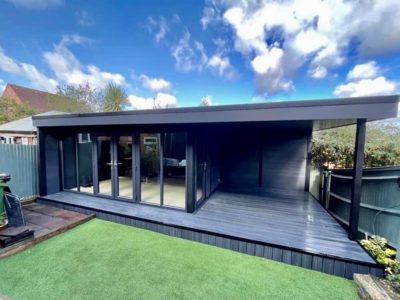 Large Decking Area With Black Posts And Side Canopy Composite Garden Building